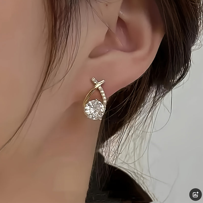 Örhängen med guldkors och zirconium